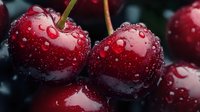 Fresh red cherries with water droplets, stems attached, isolated on dark background. Suitable for food photography, culinary designs, healthy eating content, and beverage packaging.