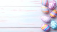 Decorated Easter eggs in pastel colors with ornate patterns arranged on white wooden planks background with copy space for seasonal holiday designs.