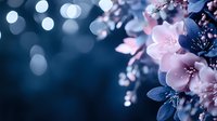 Delicate pink cherry blossoms against dark blue background with soft bokeh lights creating dreamy spring atmosphere. Macro floral composition with shallow depth of field.