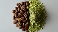 Contrast of roasted coffee beans and matcha green tea powder on gray background, showcasing popular caffeinated ingredients for beverages and desserts.