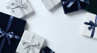 Wrapped gift boxes in navy blue and silver with ribbon bows arranged on white background, suitable for holiday, celebration, and festive design projects.