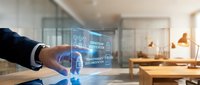 Young professional male with medium skin tone wearing dark business suit interacting with holographic smart home control interface displaying connected device icons and data in modern office environment.
