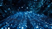 Glowing blue particles and bokeh lights create magical atmosphere with depth and perspective on dark background. Suitable for technology and science designs.