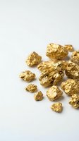 Golden nuggets scattered on white background representing precious metal mining wealth and investment opportunities for financial concepts.