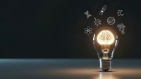 Glowing light bulb with gear mechanisms inside surrounded by floating cog wheels on dark background representing innovation and creative thinking process.