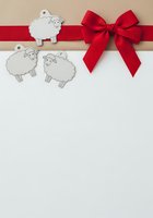 Sheep gift tags with red ribbon bow on white background, isolated design ready for greeting cards, gift wrapping, and holiday packaging projects.