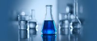 Laboratory glassware with blue chemical solution in conical flask for scientific research and experimentation in modern chemistry lab setting.