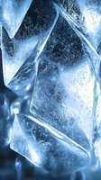Macro shot of crystal clear ice cubes with intricate internal patterns and cracks illuminated by blue light, creating dramatic shadows and reflections for beverage photography.