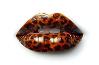 Glossy lips with leopard print pattern in orange and black colors isolated on white background for fashion and beauty design projects.