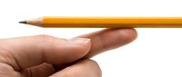 Close-up of a hand holding a sharpened yellow pencil against a white background, suitable for education, writing, and design projects.
