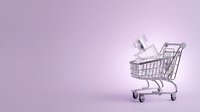 Shopping cart filled with white boxes on purple gradient background, representing e-commerce, online retail, and digital shopping solutions.