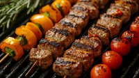 Grilled beef kebabs with cherry tomatoes and mini peppers on skewers, charred with grill marks. Juicy meat and colorful vegetables cooking on barbecue grate.