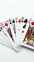 Playing cards fanned out on white background showing diamonds, clubs and hearts suits with numbered and face cards for gaming and entertainment purposes.