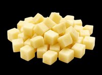 Diced cheese cubes isolated on transparent background, ready for culinary design, food packaging, recipe graphics, cooking blogs, restaurant menus, and print-on-demand food illustrations.