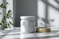 White glass jar with gold lid on marble surface in natural window light with plant shadow and green leaves, minimalist cosmetic packaging mockup.
