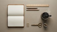 Minimalist workspace flat lay with open notebook, wooden ruler, pencils, scissors, paper clips and black coffee cup on beige background for creative projects.
