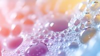 Colorful soap bubbles with rainbow light reflections creating dreamy bokeh effect on soft gradient background for wellness and beauty concepts.