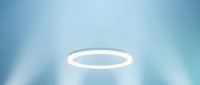 Glowing white halo ring floating against soft blue blurred background with light rays, suitable for spiritual, religious, or divine concept designs.