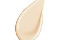 Smooth cream drop with peach-toned gradient on white background, isolated cosmetic texture for skincare and beauty product design.