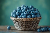 Fresh ripe blueberries in wicker basket on wooden table with turquoise background for healthy eating and organic food concepts.