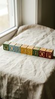 Colorful vintage wooden alphabet blocks spelling WORKSHOP on linen fabric near a sunlit window, concept for education and training.