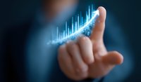 Businessman pointing at glowing digital growth chart graph showing positive trend analysis and financial success statistics on dark background.