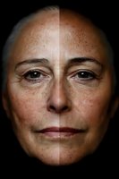 Close-up portrait showing skin texture comparison with split lighting effect on mature woman's face against dark background, demonstrating aging and skincare concept.