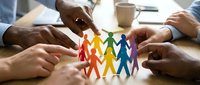 Diverse hands protecting colorful paper cutout figures in circle, representing unity, teamwork, community support, and inclusive collaboration for corporate social responsibility initiatives.