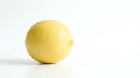 Fresh yellow lemon fruit isolated on white background for culinary design and healthy cooking projects.