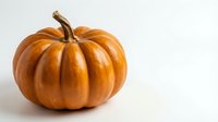Orange pumpkin with natural stem isolated on white background for autumn harvest decorations and seasonal design projects.