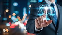Professional businessman touching digital justice scales hologram interface with glowing legal technology symbols against blurred city lights background at night.