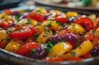 Colorful cherry tomatoes and mini bell peppers seasoned with herbs and spices in glass baking dish, macro food photography showing fresh produce ready for roasting.
