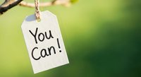 White paper tag with You Can motivational message hanging on rope against blurred green nature background for inspiration and encouragement concepts.