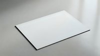 Blank white paper sheet on gray surface for mockup design templates and branding presentations in minimalist office workspace setting.