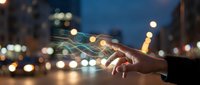 Hand holding smartphone with glowing digital network connections overlay against blurred city lights at dusk for technology and communication concepts.