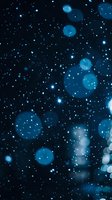 Abstract blue bokeh lights and stars on dark background creating dreamy celestial atmosphere for digital design and creative projects.