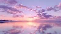 Stunning purple and pink sunset over calm lake with perfect reflections creating dreamy twilight atmosphere for relaxation and meditation backgrounds.