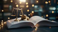Golden scales of justice on open law book with decorative bokeh lights creating atmospheric legal ambiance, symbolic representation of law and justice system.