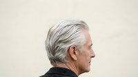 Senior man with gray hair in profile view against neutral background, suitable for healthcare, aging, wellness, and corporate applications.