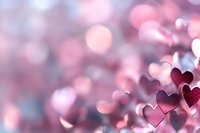 Delicate pink heart shapes with soft bokeh background create romantic atmosphere. Dreamy macro photography with blurred lights for Valentine's Day and love themes.