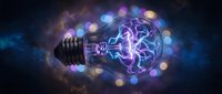 Glowing light bulb with electric brain inside surrounded by colorful bokeh lights on dark background representing innovation and creative thinking concepts.