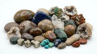 Collection of natural gemstones and minerals including quartz, agate, pyrite and turquoise specimens isolated on white background for jewelry making and geology study.