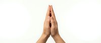 Two hands pressed together in prayer position against white background, isolated for spiritual meditation wellness and gratitude concepts.