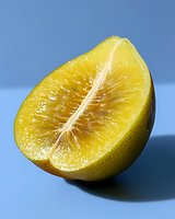 Fresh juicy lemon half showing detailed pulp texture and natural citrus segments against blue background, macro food photography for healthy lifestyle content.