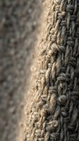 Close-up macro shot of natural jute rope texture with detailed fiber weaving patterns and rustic brown tones for nautical and craft projects.