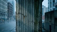 Urban concrete pillar with weathered texture stands prominently in modern city street with blurred buildings and soft lighting creating atmospheric depth.