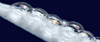 Clear orthodontic aligners arranged in sequence on dark blue background showing teeth straightening treatment progression for dental care.
