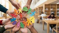 Male and female hands of diverse ethnicities joining together holding colorful paper cutout figures in circle formation, symbolizing teamwork, unity, and community support in library or educational setting.