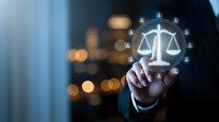 Professional businessman touching digital justice scales icon with glowing network connections in modern office environment for legal technology concepts.