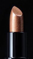 Metallic rose gold lipstick with sparkly shimmer texture against black background, close-up macro shot showing luxurious cosmetic detail and glossy finish.